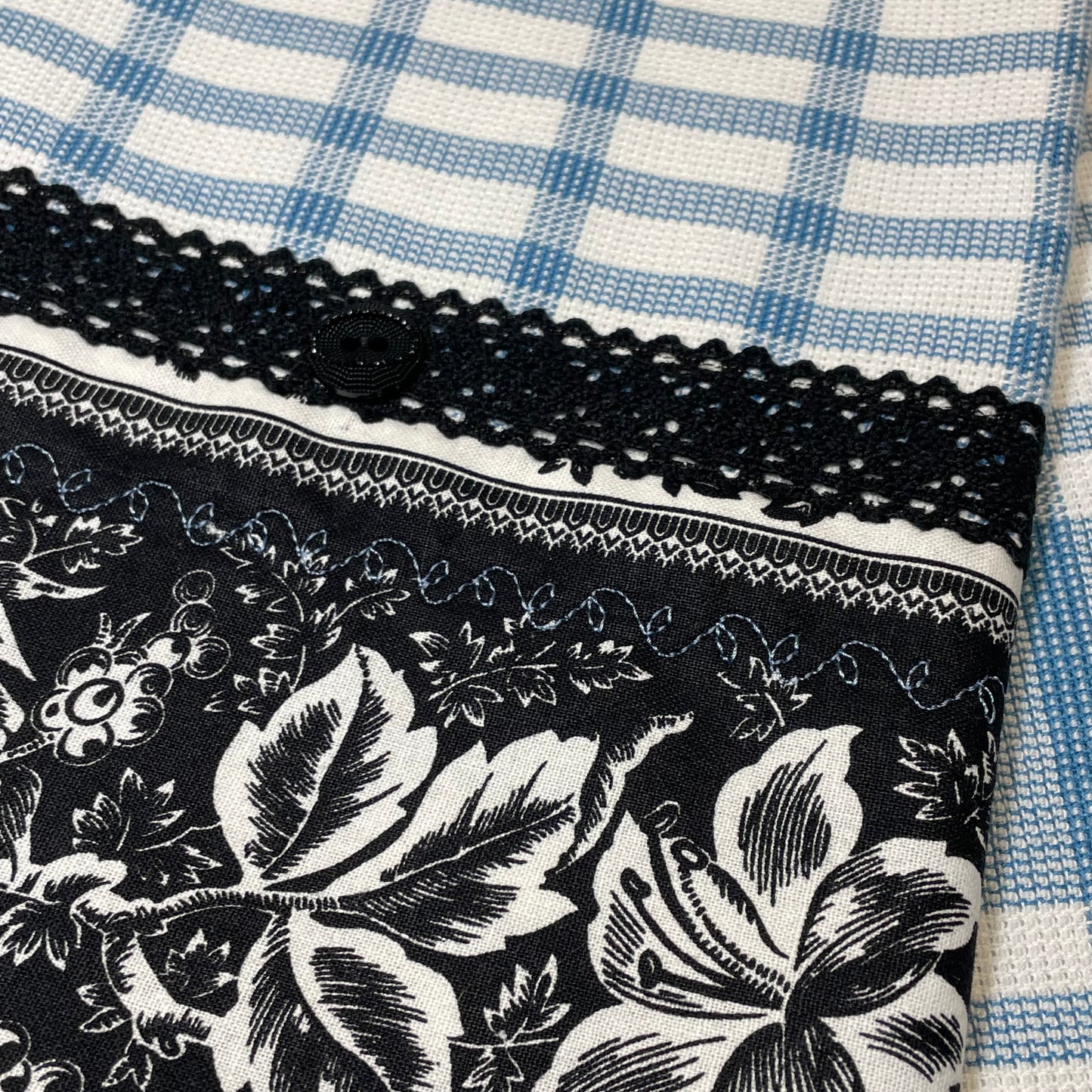 Blue and Black decorative tea towel handcrafted in Canada. Blue Embroidery Stitching, Black Cotton Lace Trim and Black button. Purchase your favorite or learn to make your own with tutorials on the Home Stitchery Decor YouTube Channel.